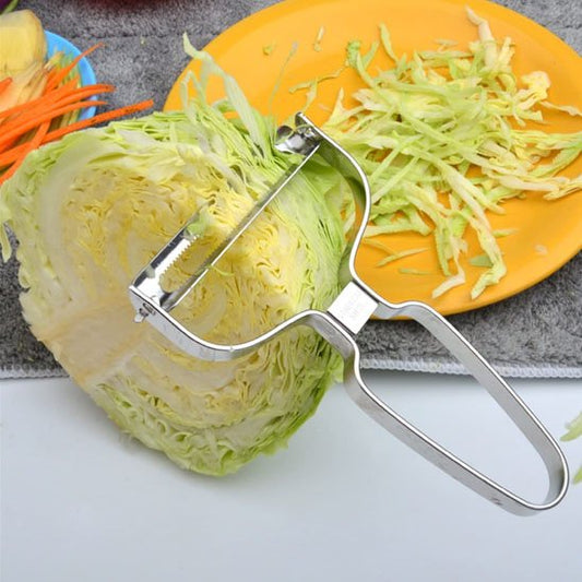 économe cuisine en métal râpe chou à coté assiette jaune